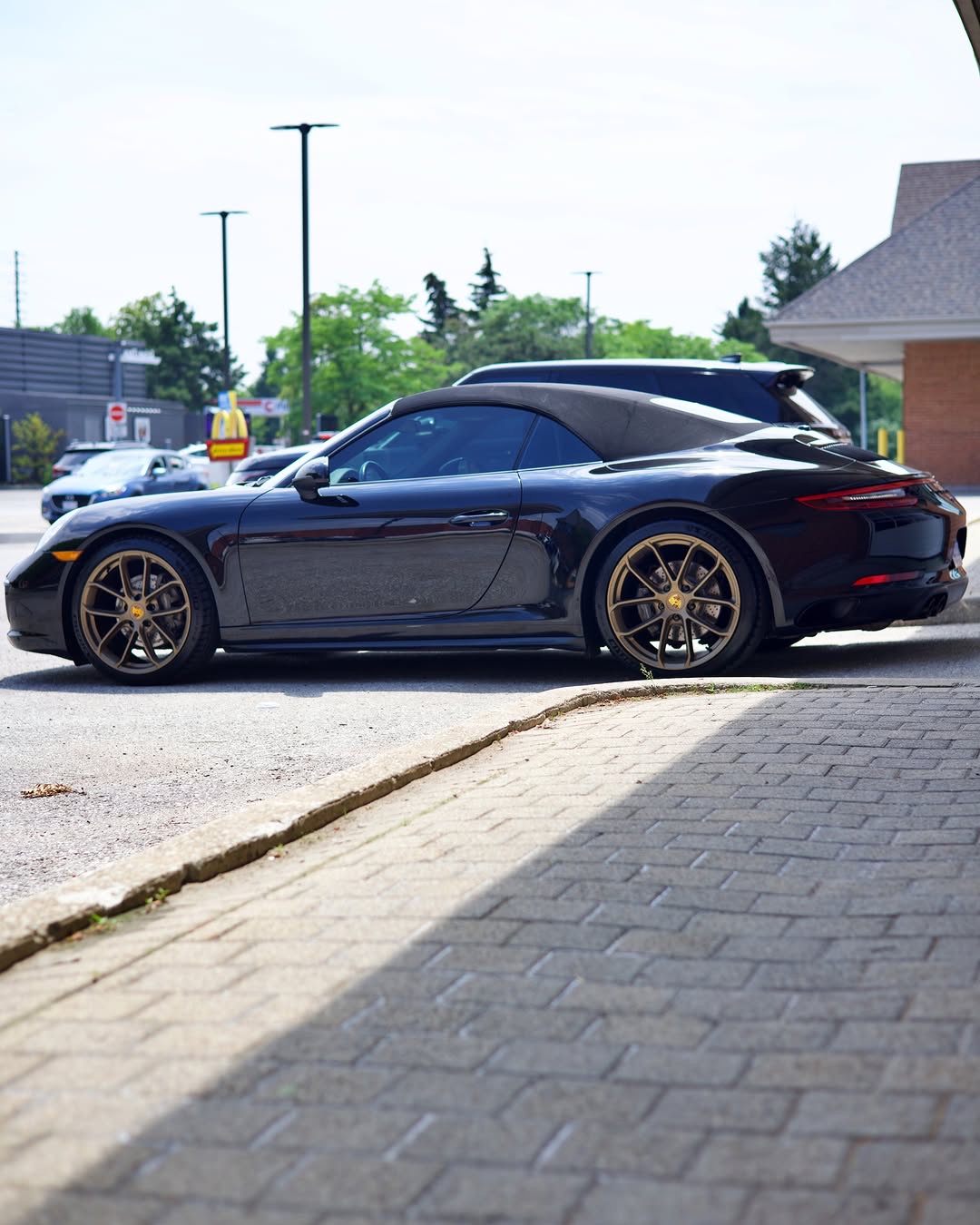 Dark vehicle in side profile with freshly installed ceramic window tint